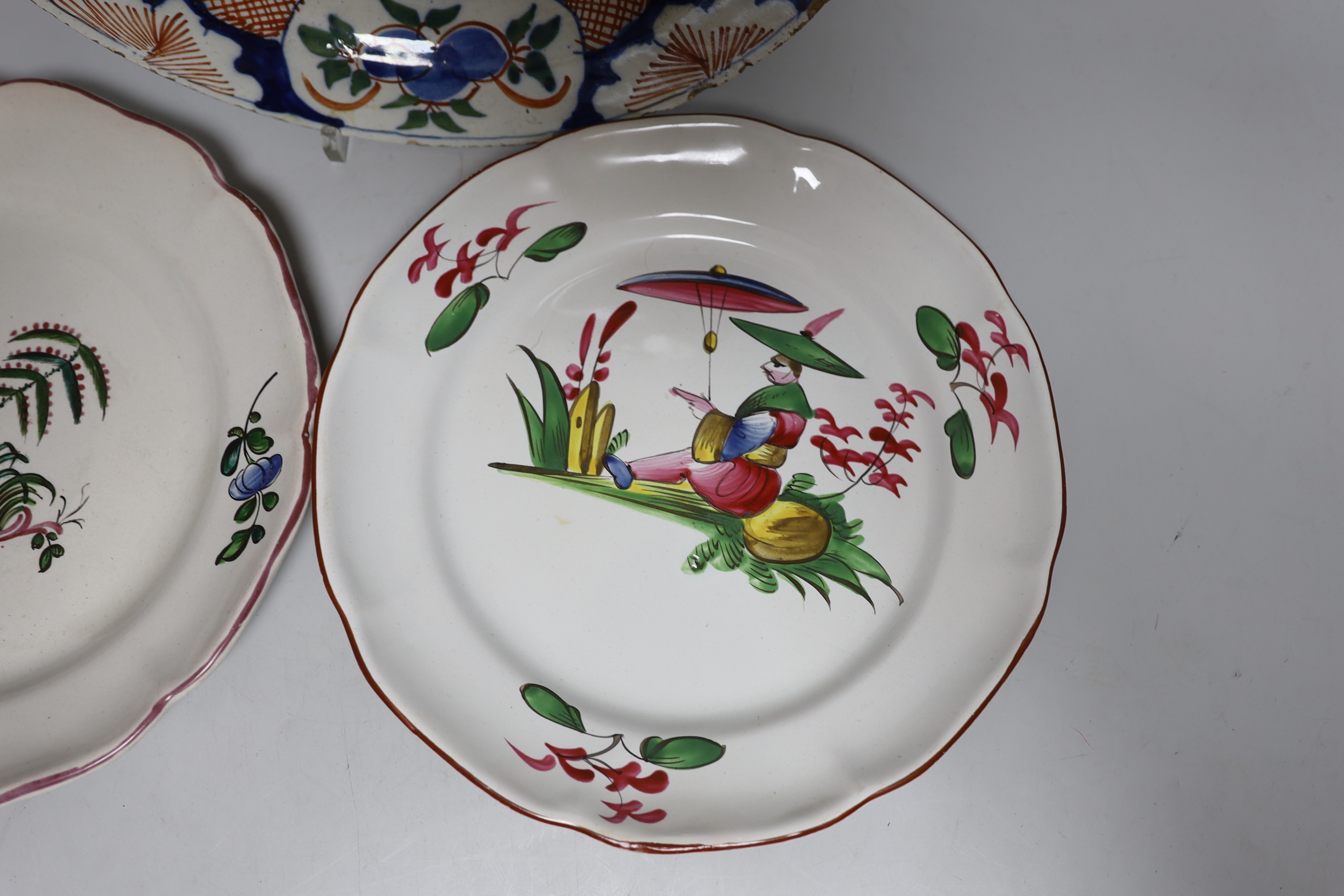 An 18th century Delft plate and three 19th century faience plates, largest 26cm diameter (4)